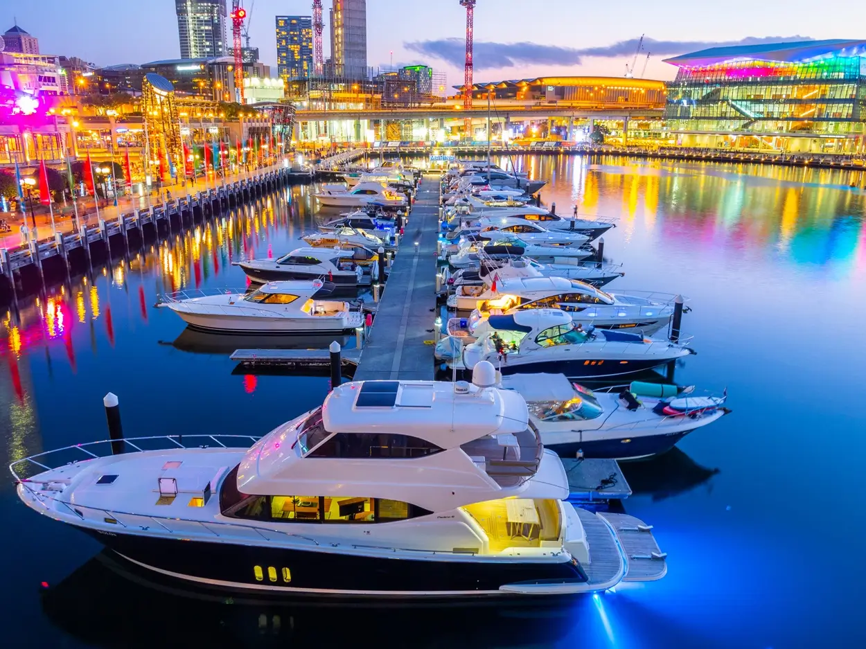 Darling Harbour, Sydney, at night, with multi-coloured lights and boats on the water