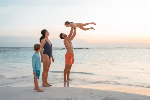 family strolling on beach