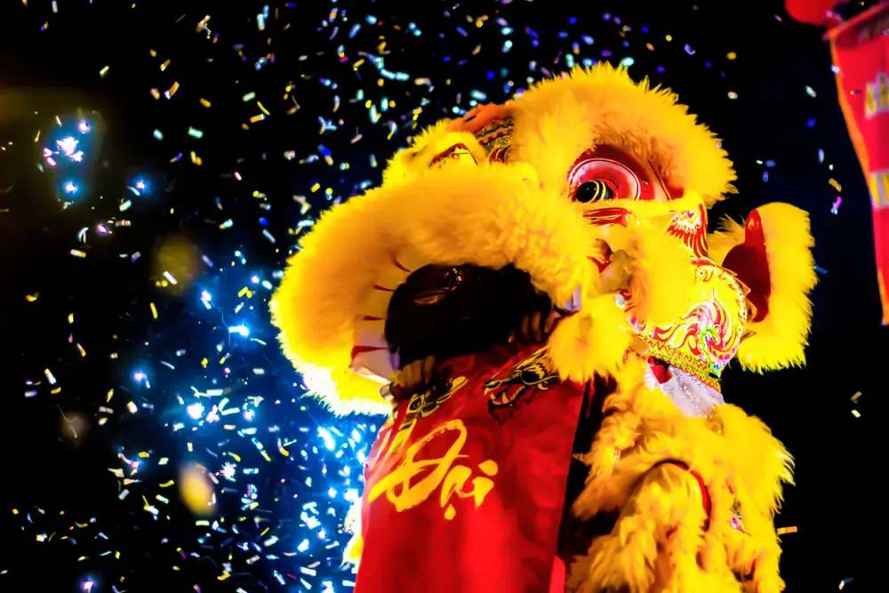 Chinese New Year celebrations, dragon surrounded by confetti